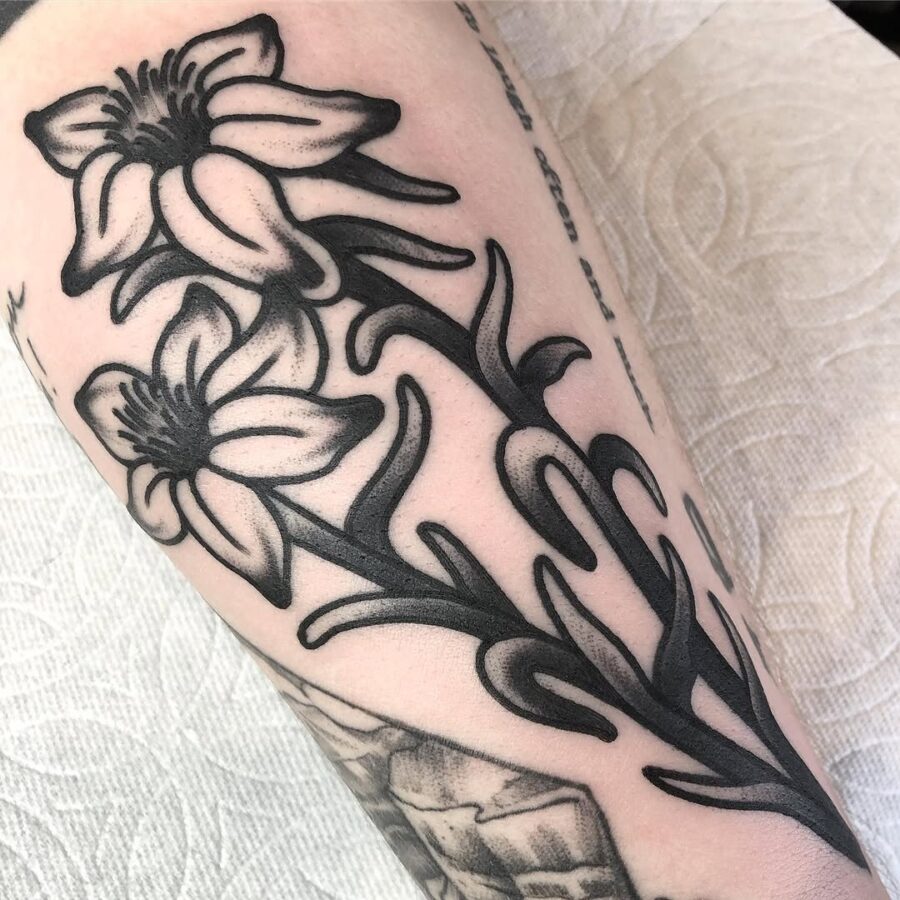 Elegant blackwork zinnia tattoo design