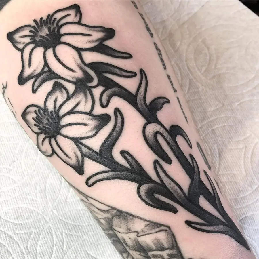 Elegant blackwork zinnia tattoo design