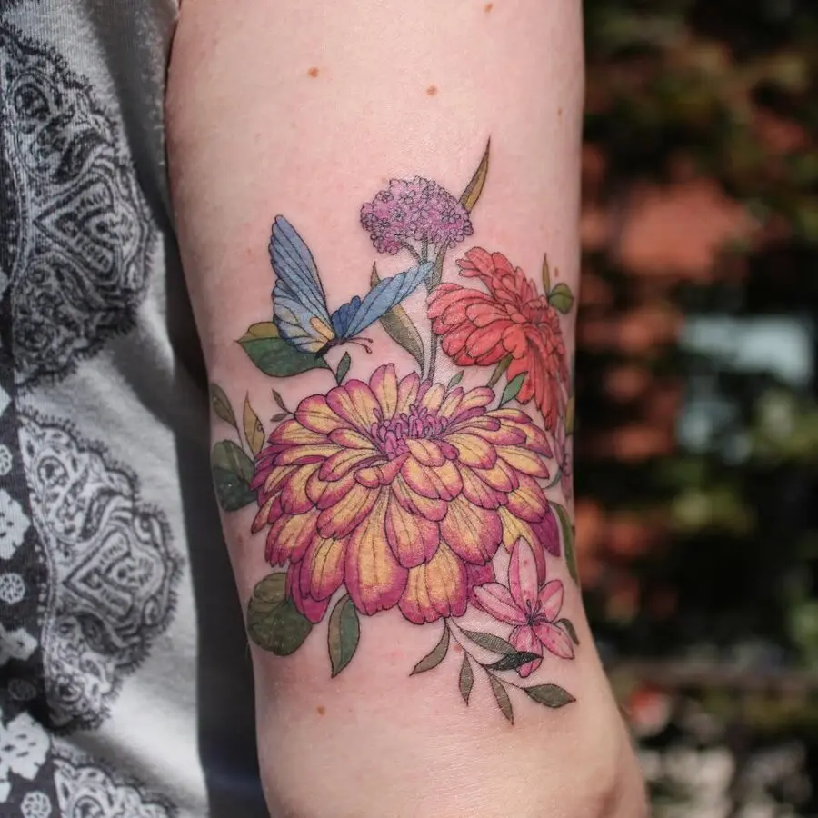 Vibrant Zinnia Tattoo with Butterfly Accents