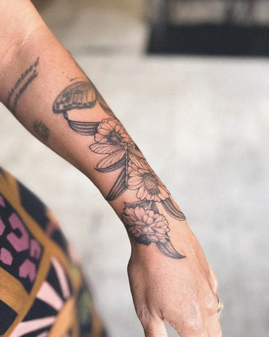 Elegant zinnia tattoo in black ink tones