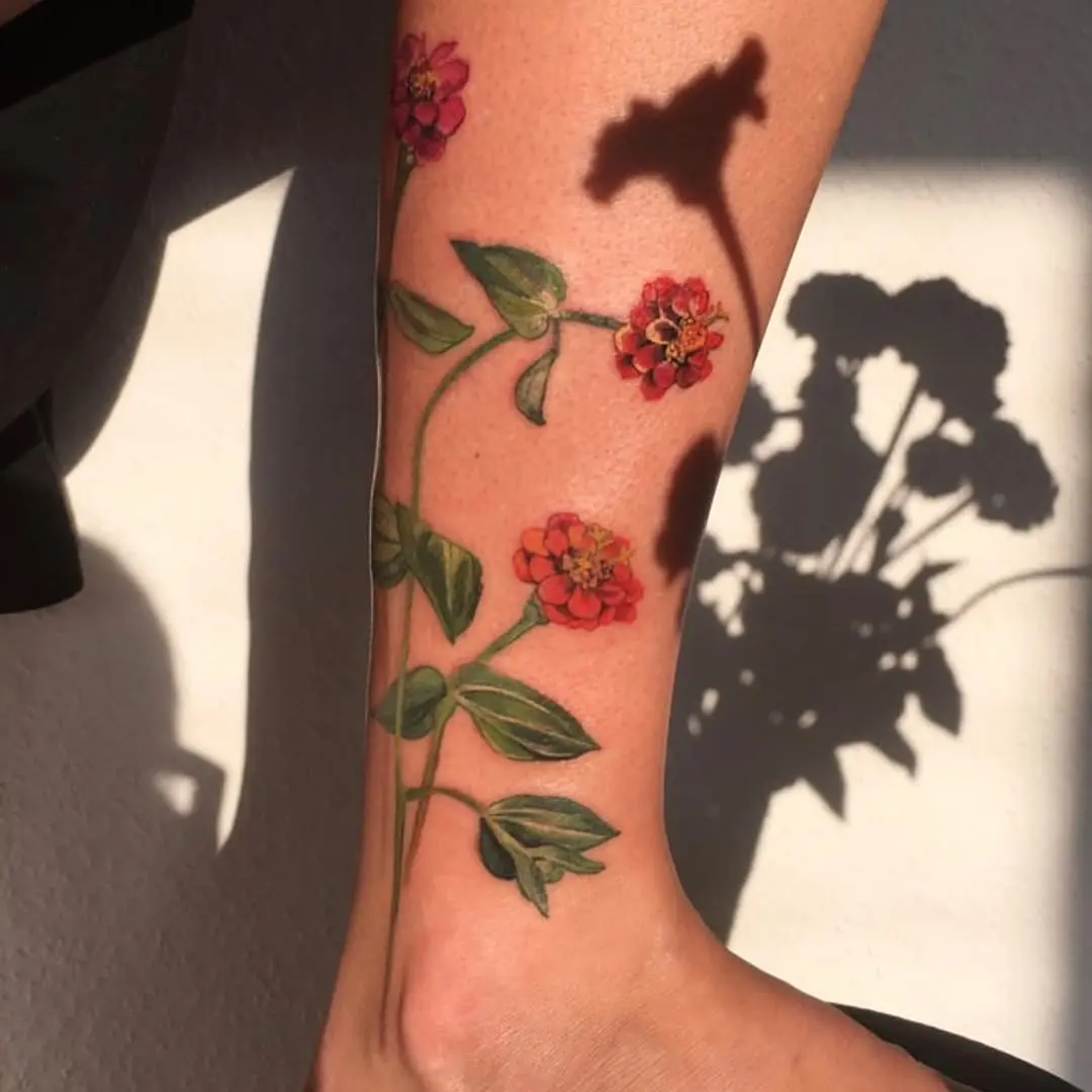 Vibrant Zinnia Tattoo on the Leg