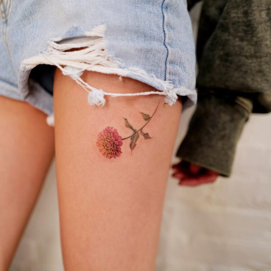 Beautiful zinnia flower tattoo on thigh