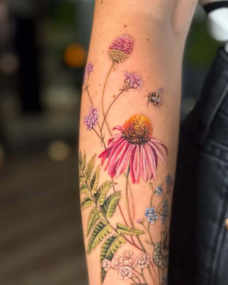 Vibrant zinnia tattoo with floral details