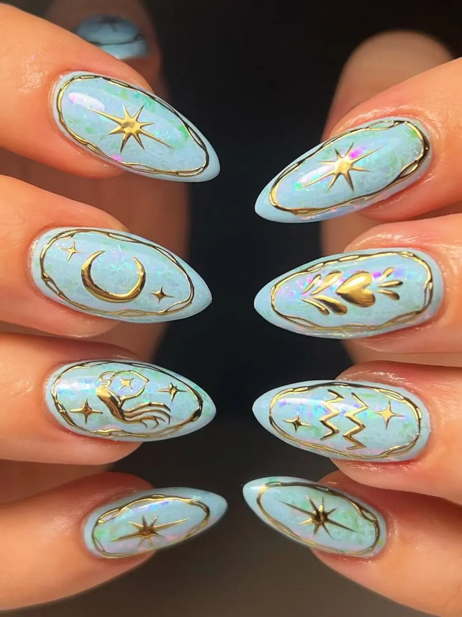 Whimsical zodiac-themed nail art with gold accents