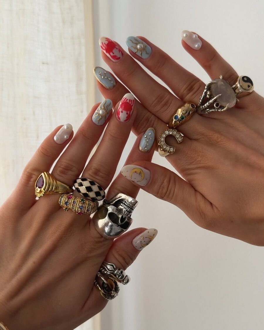 Stylish zodiac-themed nail art with accessories