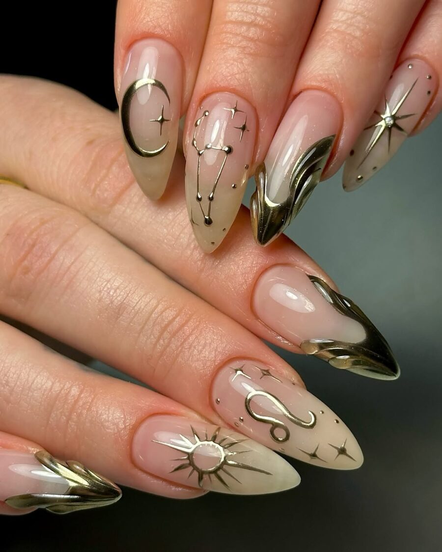 Elegant zodiac-themed nail design with gold accents