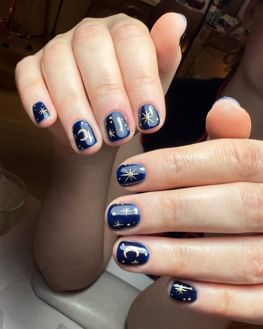Stunning zodiac-themed night sky nail art