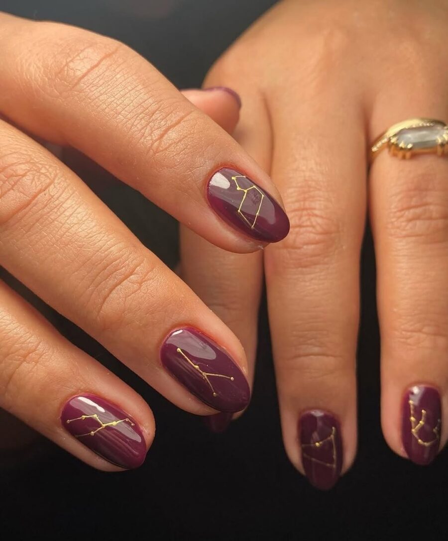 Stunning violet nails with golden constellations