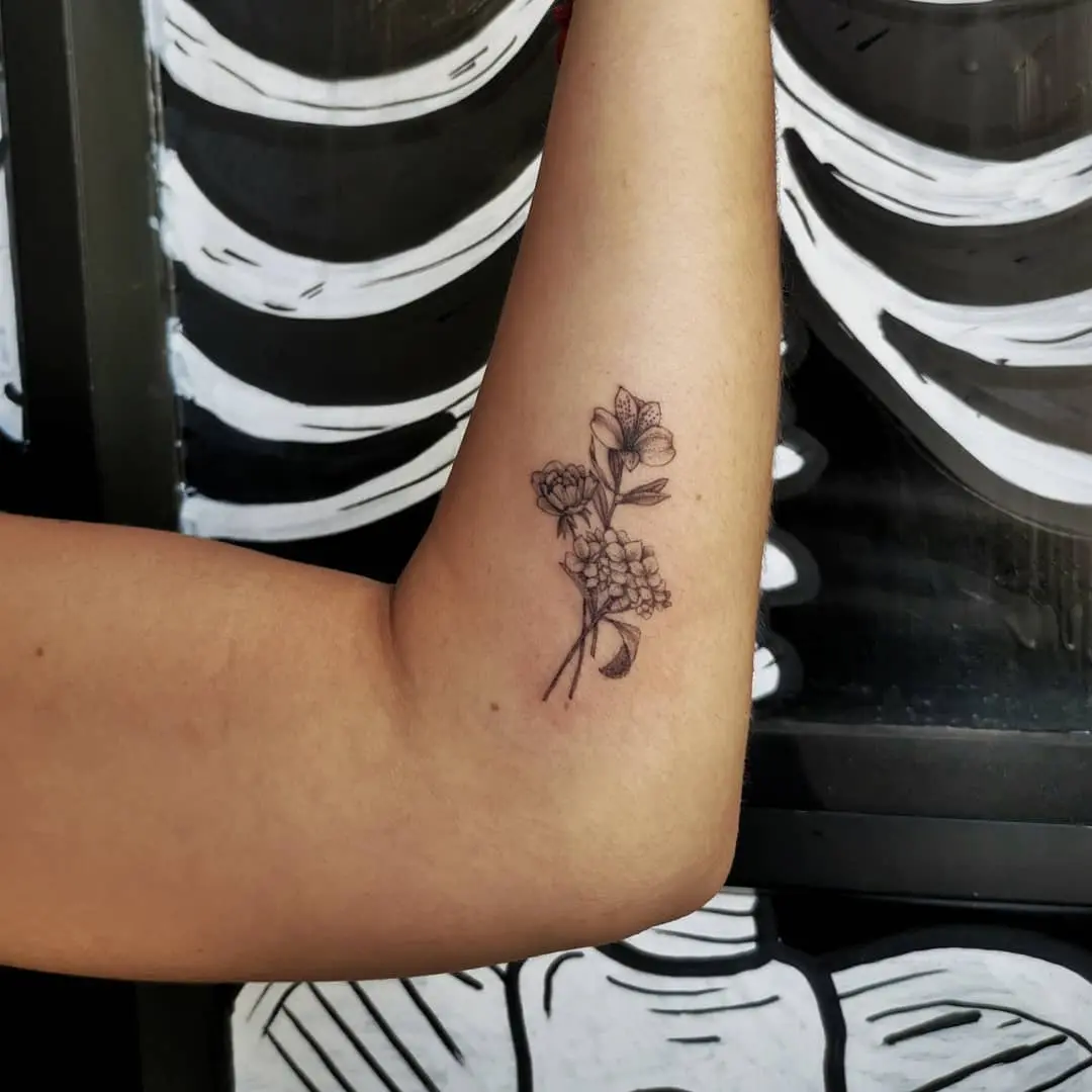 Elegant alstroemeria tattoo on a forearm