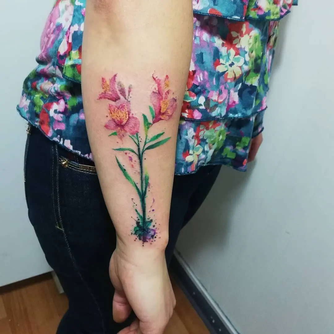 Vibrant alstroemeria tattoo with watercolor details