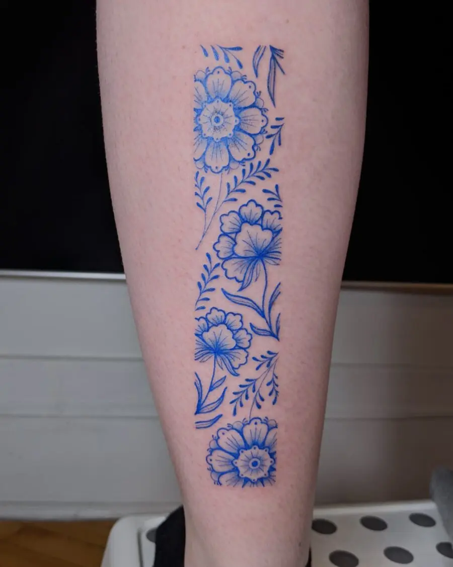 Elegant blue alstroemeria tattoo on leg