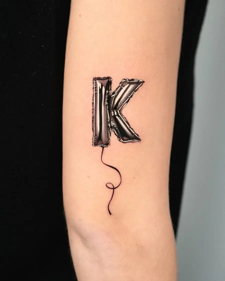 Playful balloon letter K tattoo design