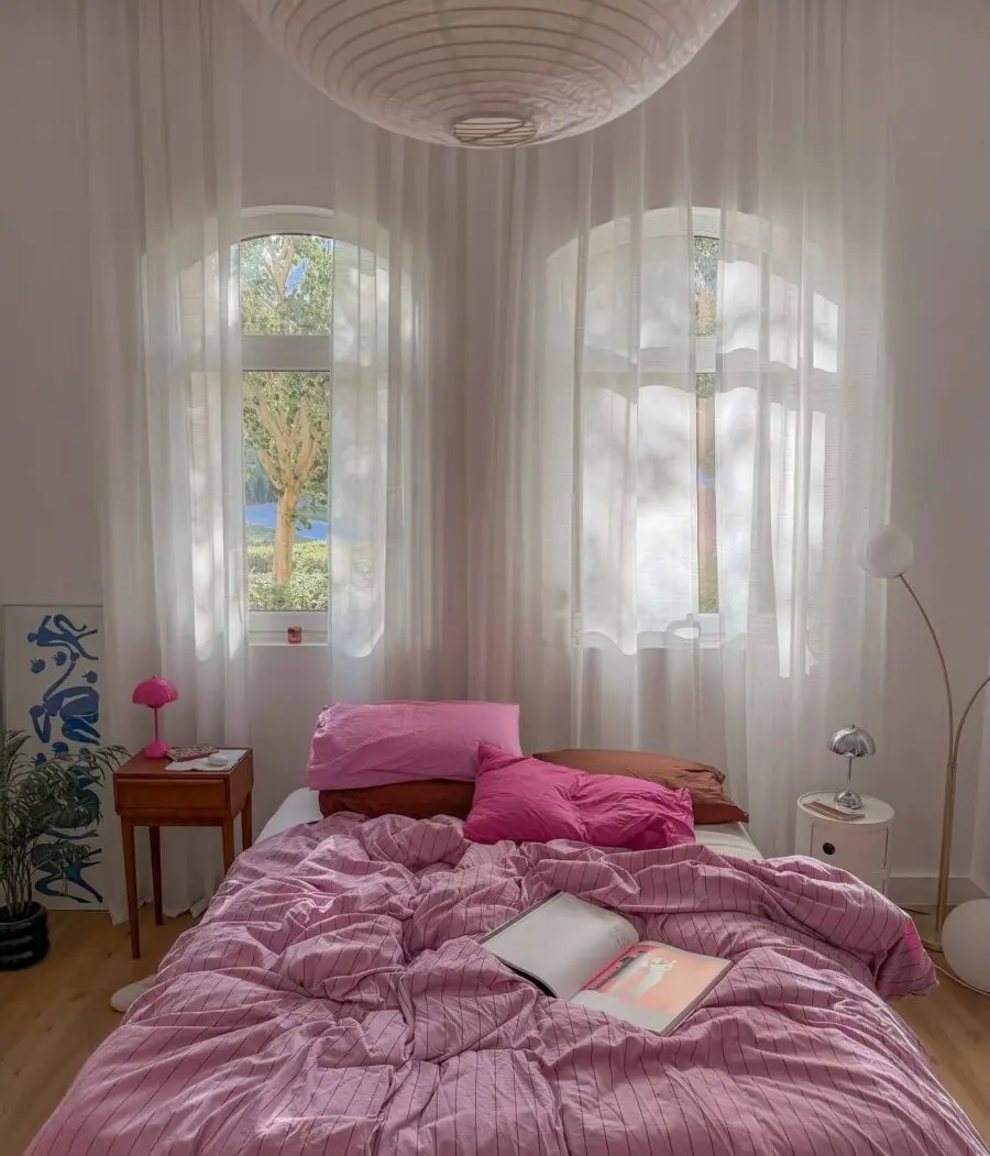 Cozy bedroom with soft pink hues and light