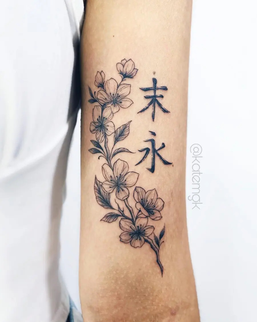 Elegant floral bicep tattoo with Japanese lettering