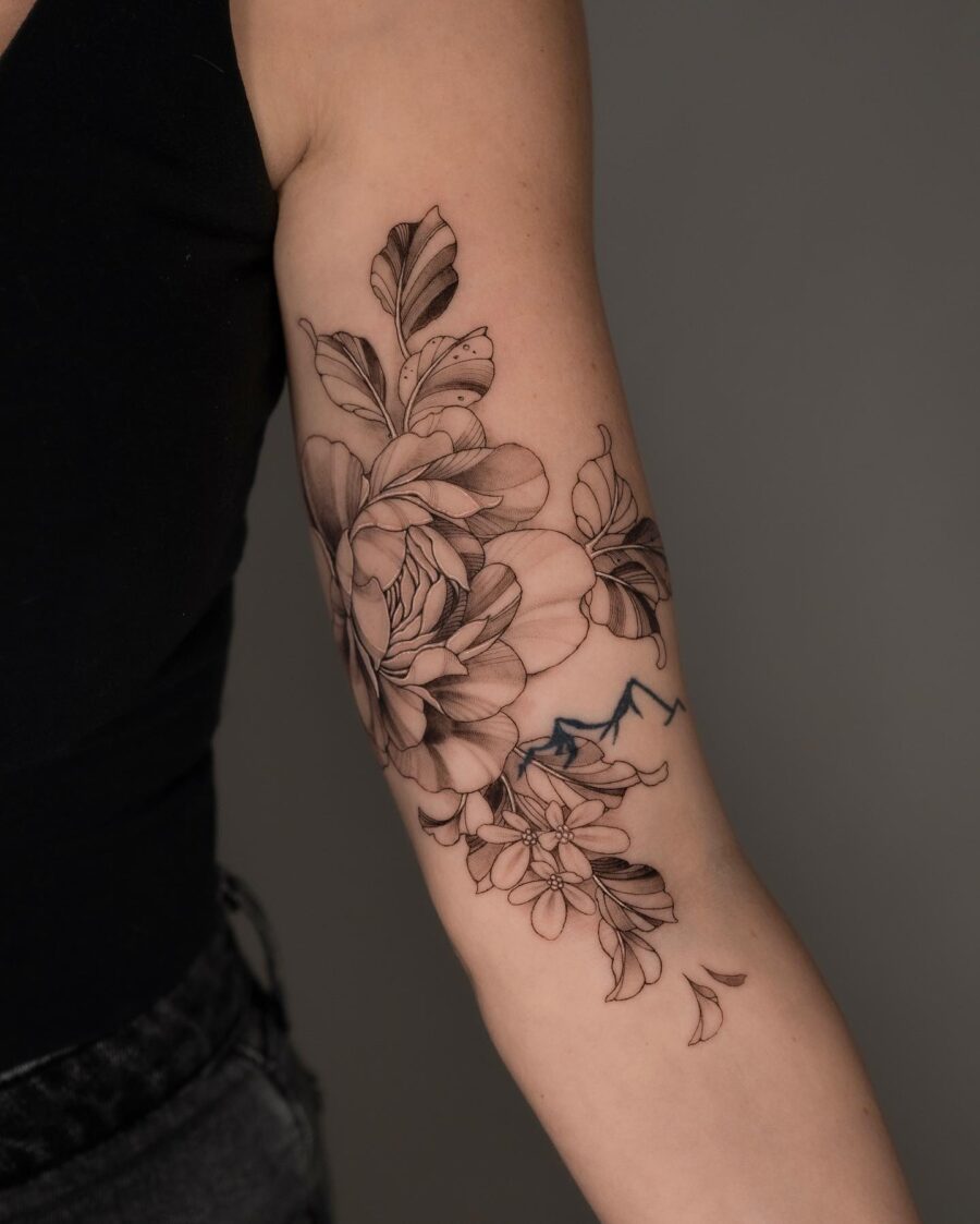 Elegant floral tattoo design on bicep
