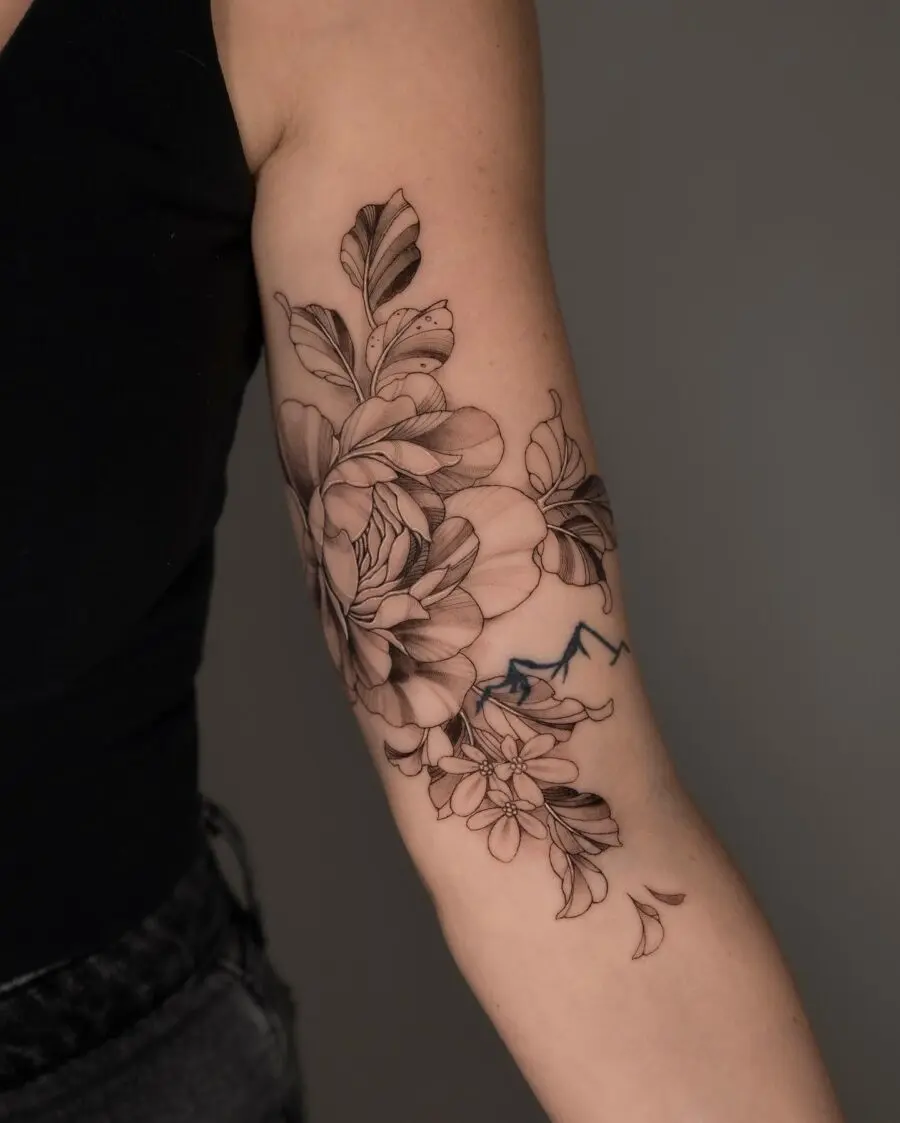 Elegant floral tattoo design on bicep