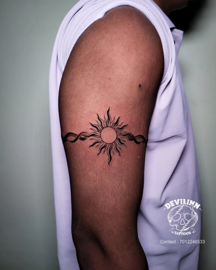 Stylish sun and infinity bicep tattoo