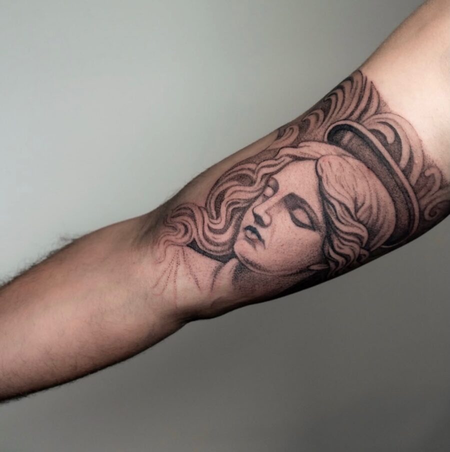 Stunning angel face tattoo on bicep