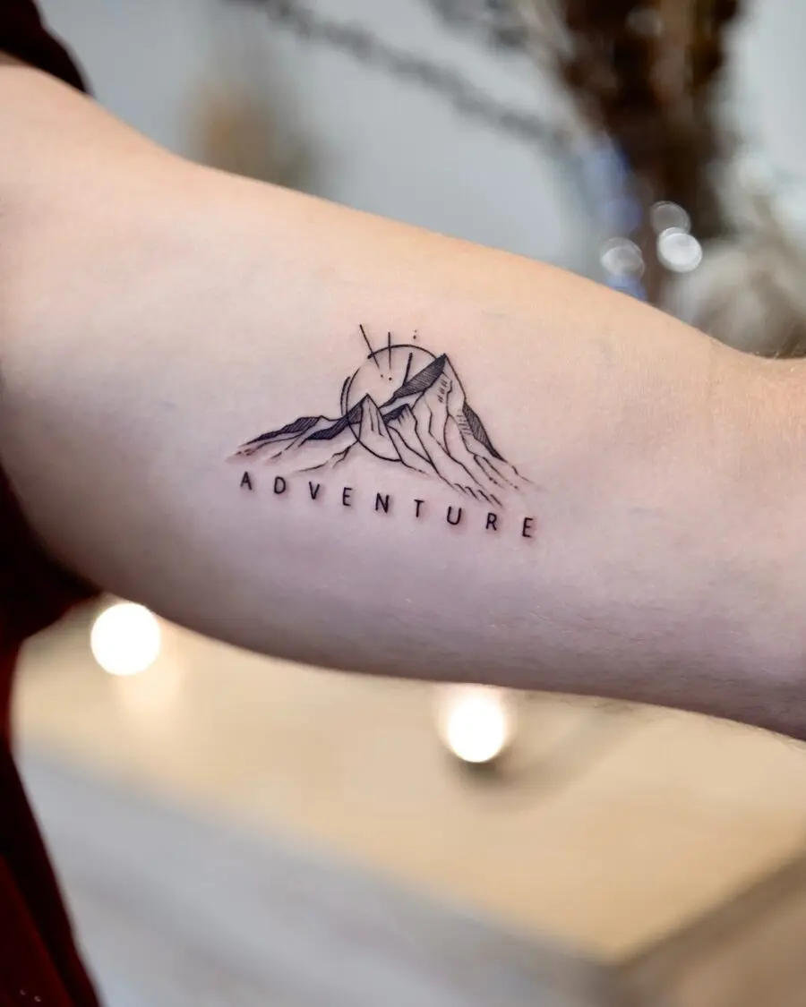 Mountain adventure tattoo with minimalistic style