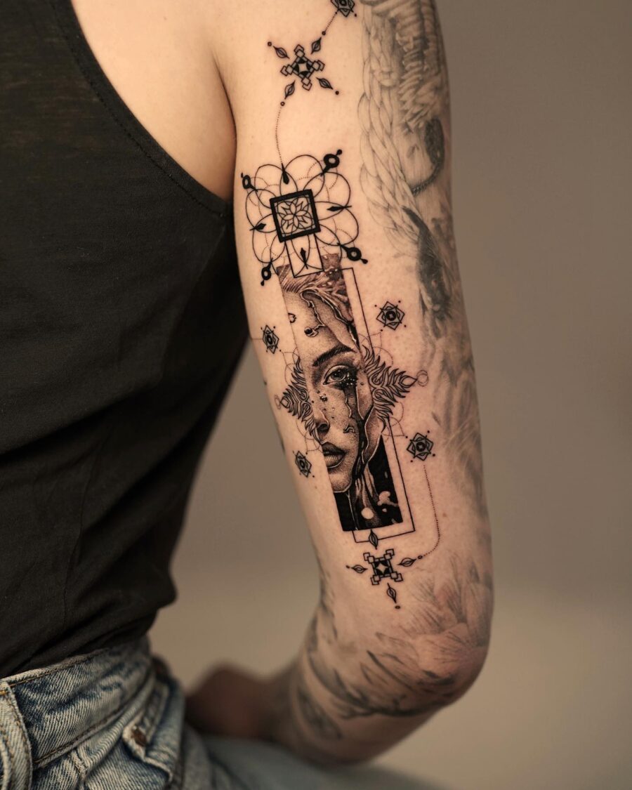 Striking blackwork tattoo of a female portrait