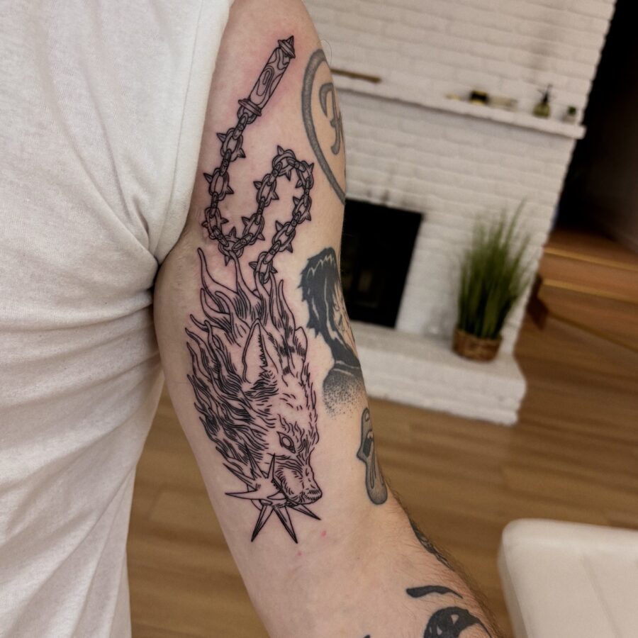Fiery fox tattoo design on bicep.