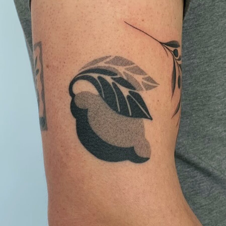 Stylish leaves tattoo on bicep