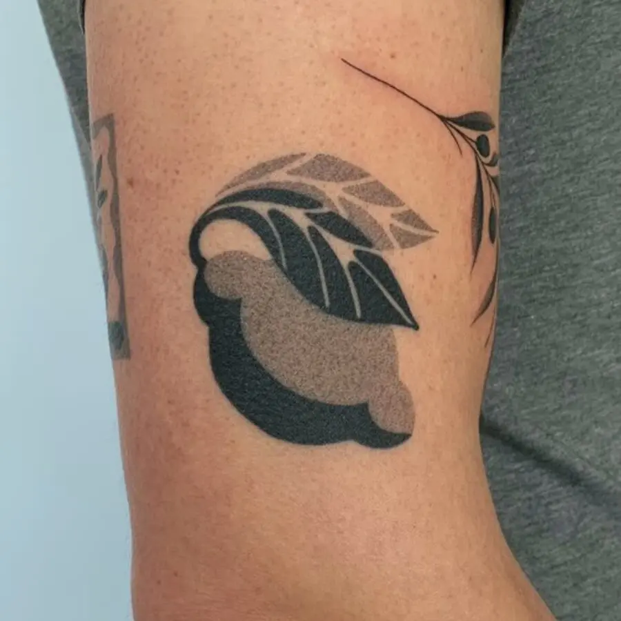 Stylish leaves tattoo on bicep