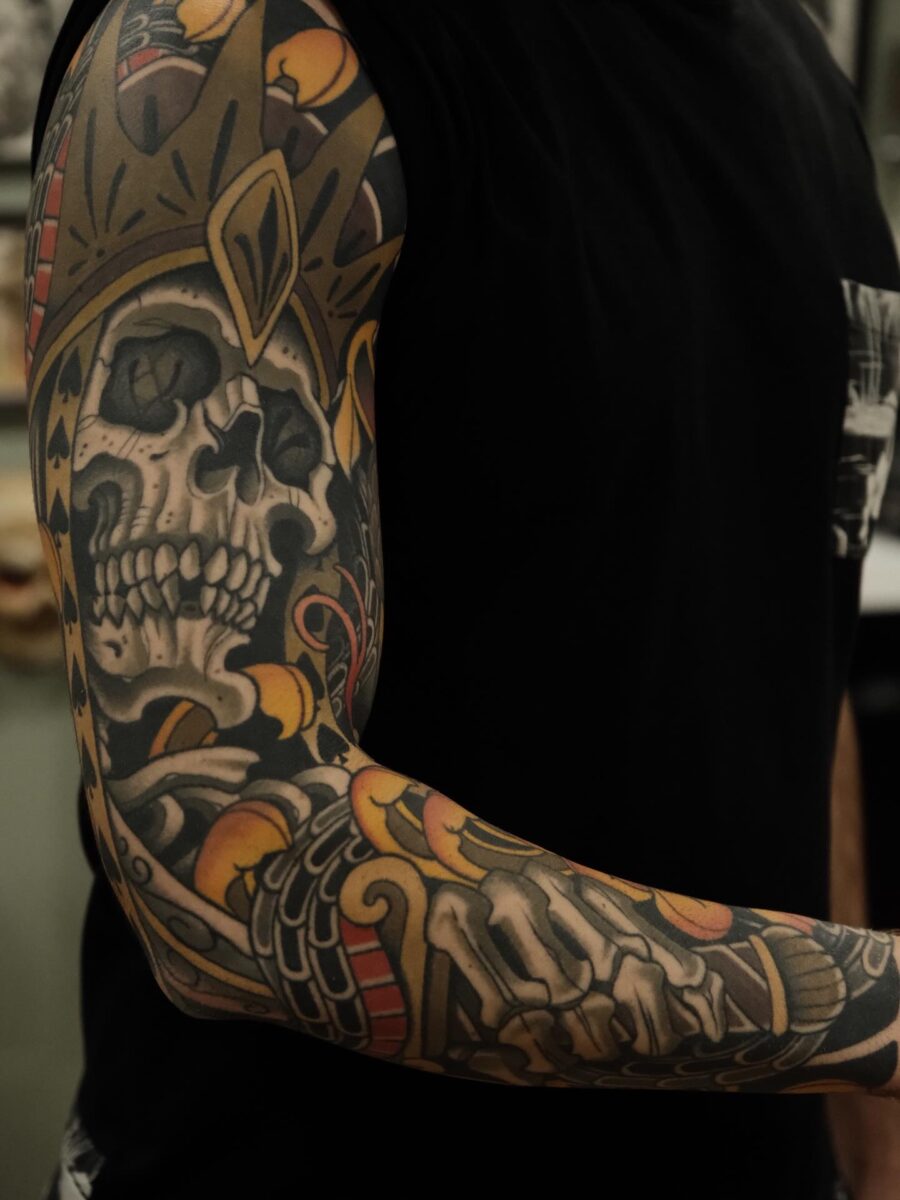 Eye-catching skeleton-themed biceps tattoo design