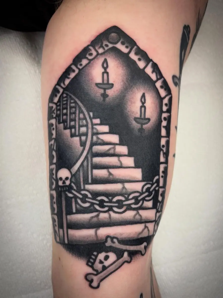 Intriguing stairway tattoo with dark vibes