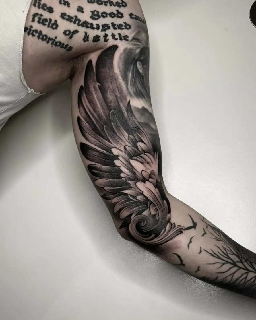 Intricate wing design on bicep tattoo