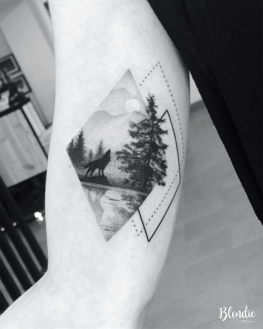 Nature-inspired wolf tattoo on bicep
