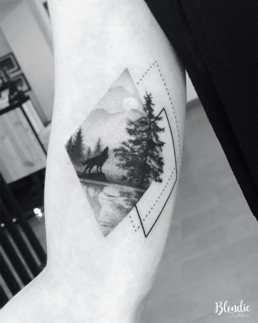 Nature-inspired wolf tattoo on bicep
