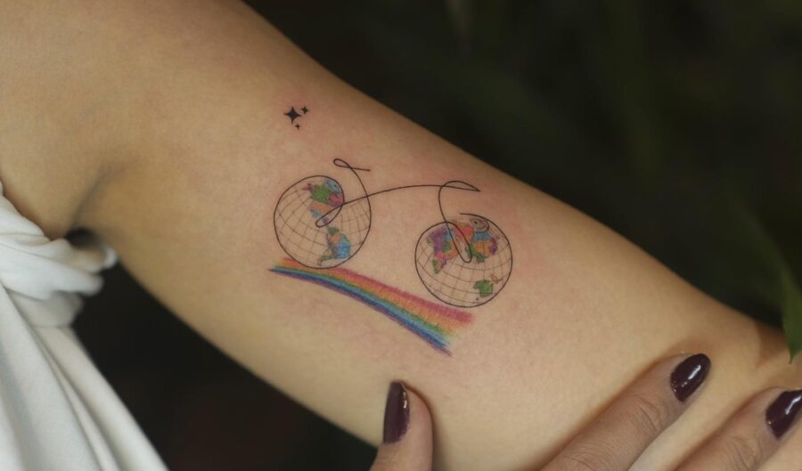 Whimsical bike tattoo with rainbow accents