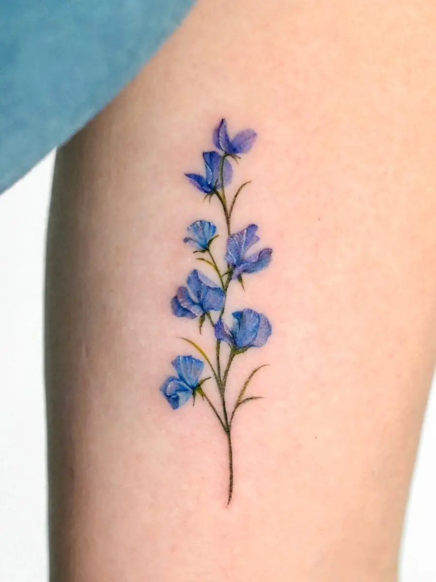 Elegant blue flower birth tattoo design on skin
