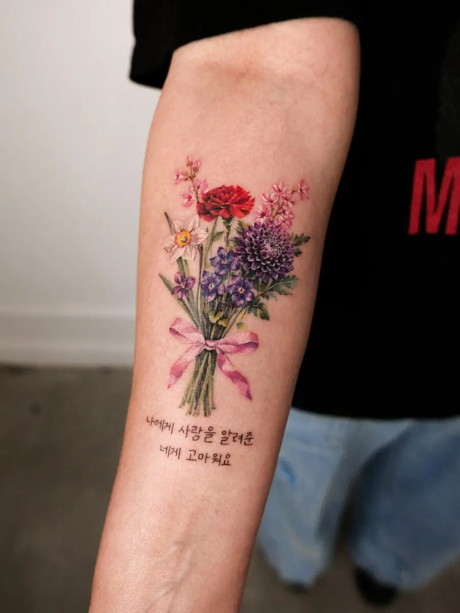 Vibrant floral bouquet tattoo with meaningful text