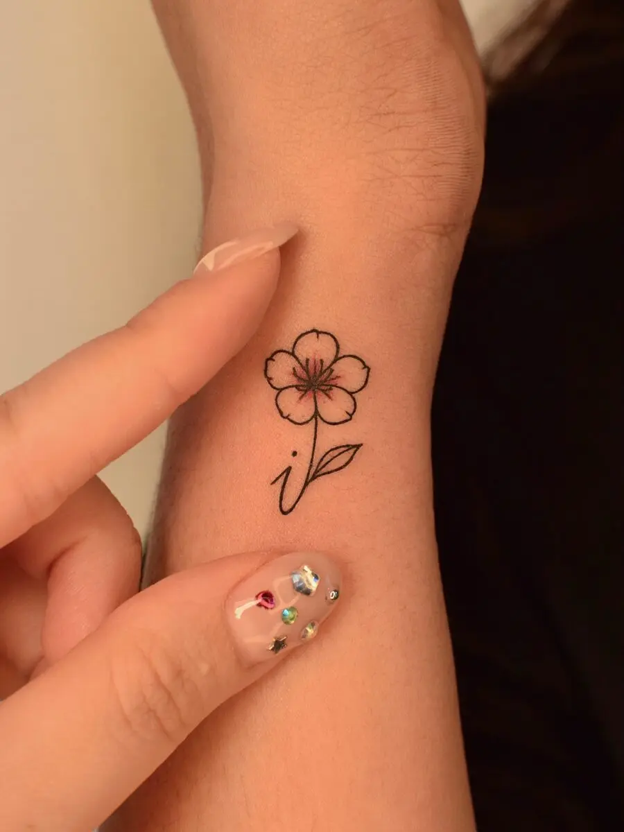 Delicate flower tattoo with elegant linework