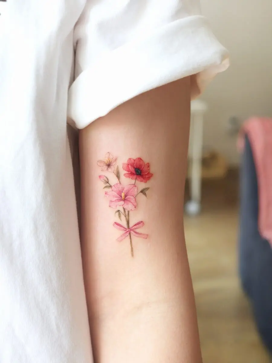 Elegant pink flower tattoo with delicate bow