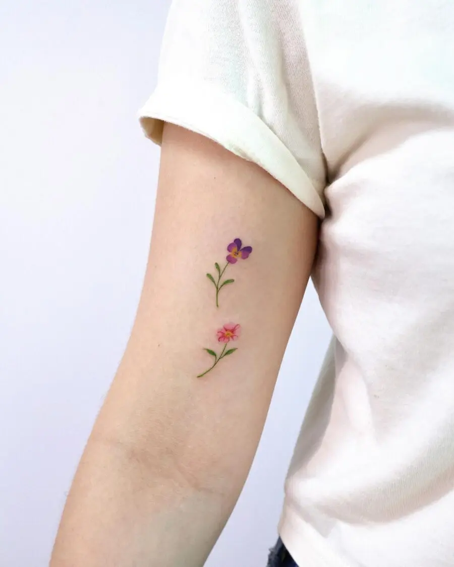 Delicate birth flower tattoos on arm