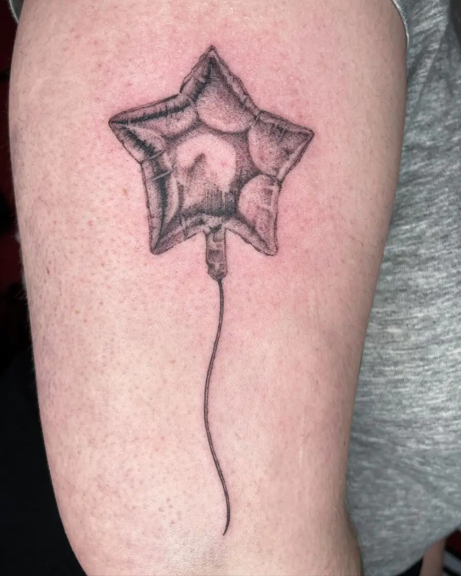 Playful balloon tattoo symbolizing joyful celebrations