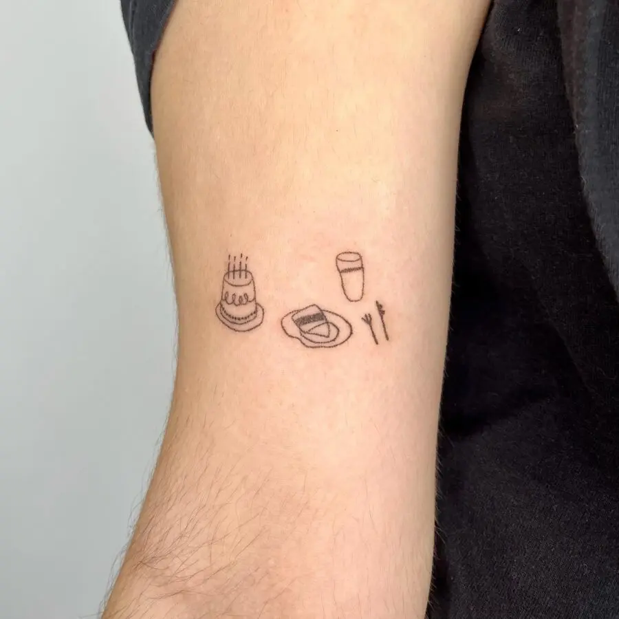 Minimalist birthday-themed tattoo design on arm