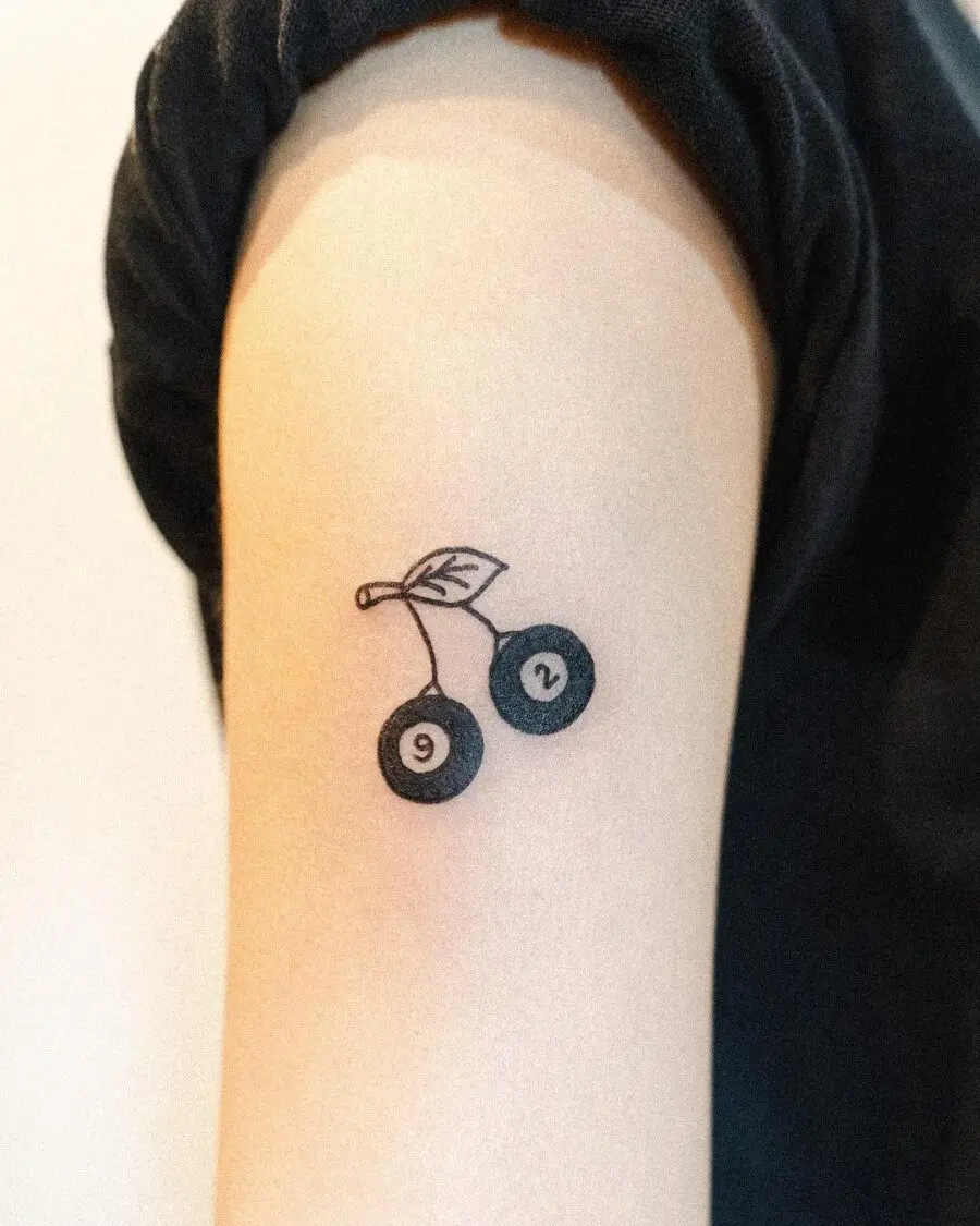 Minimalistic cherry tattoo celebrating a birthday