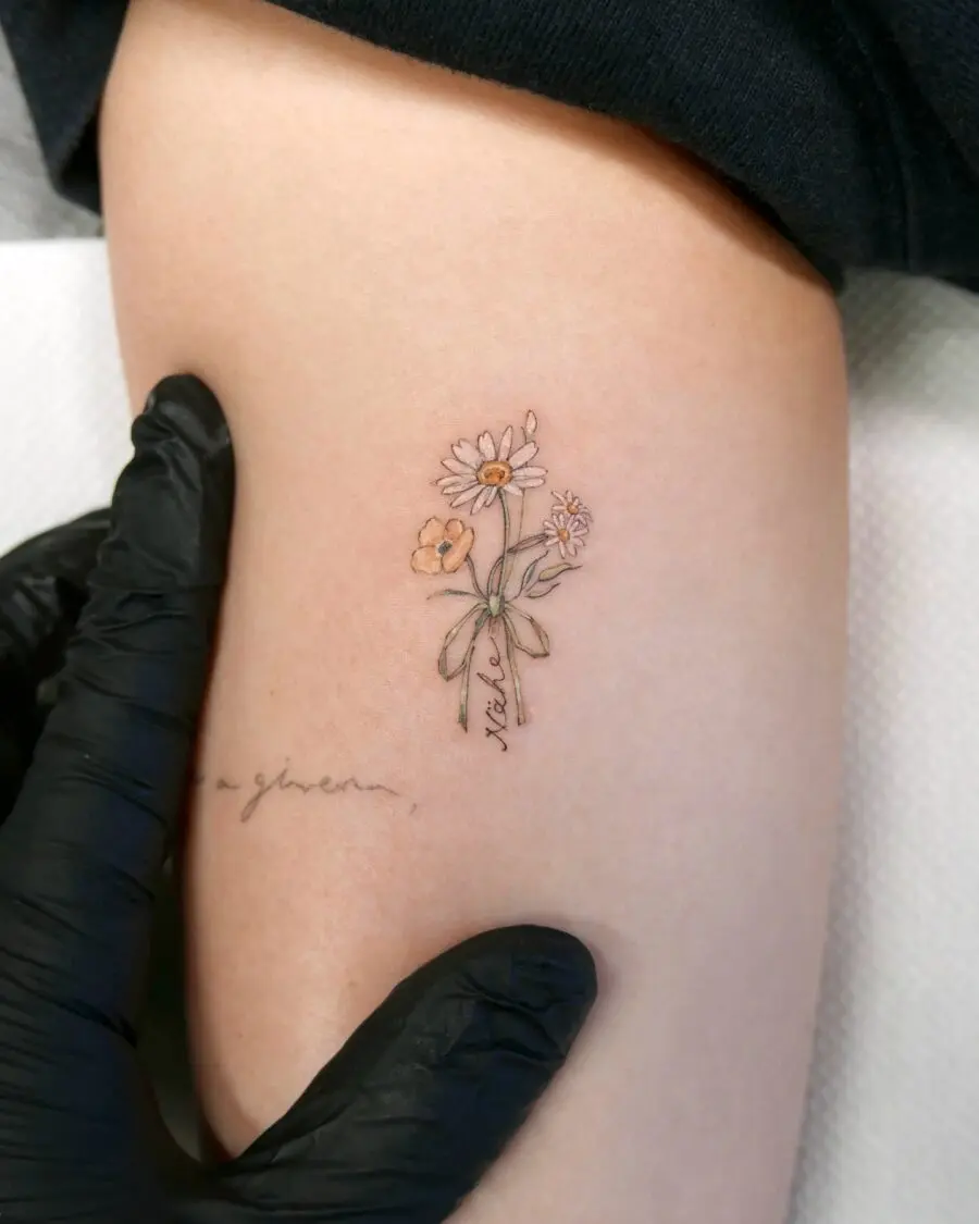 Delicate daisy tattoo with minimalist charm