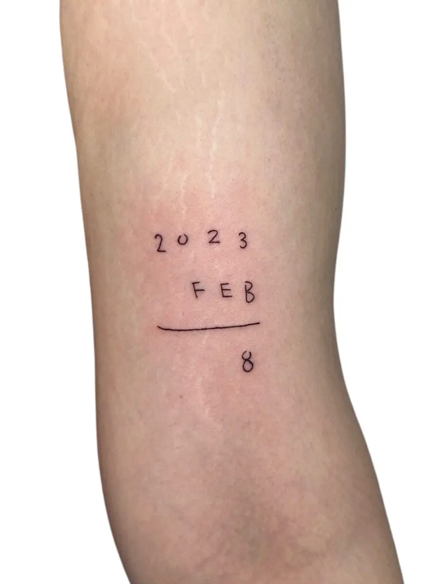 Minimalist birthday tattoo featuring significant date
