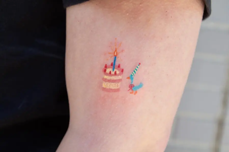 Colorful birthday cake and candle tattoo design