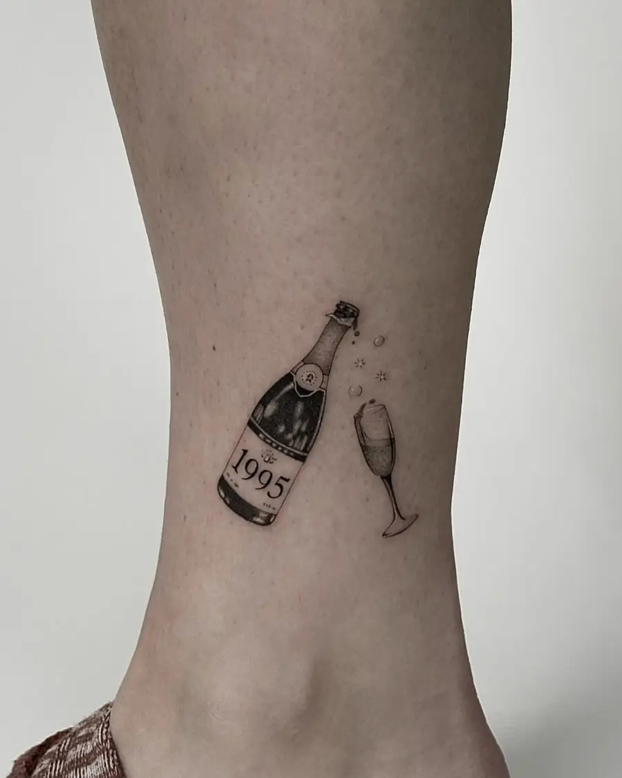 Celebrate with a charming 1995 champagne tattoo