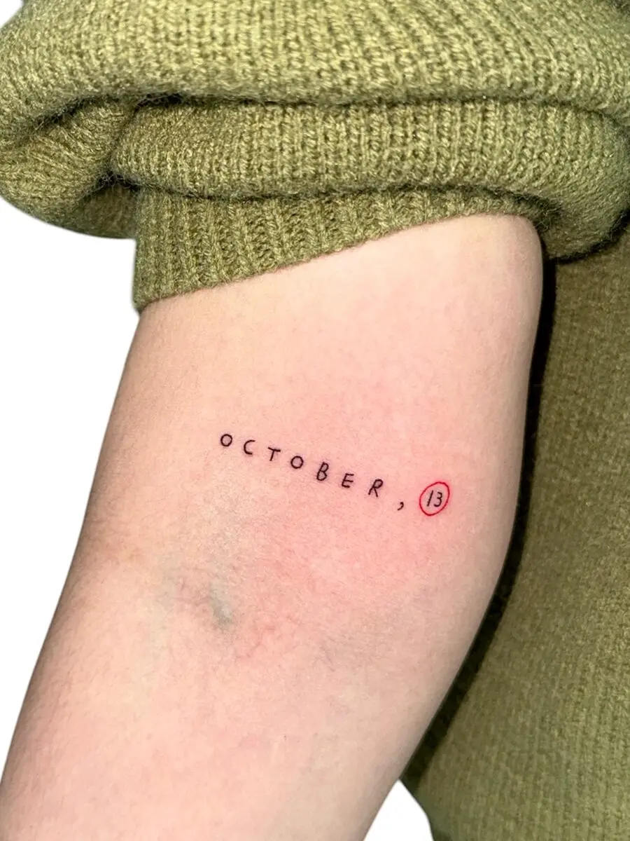 A minimalist October birthday tattoo design