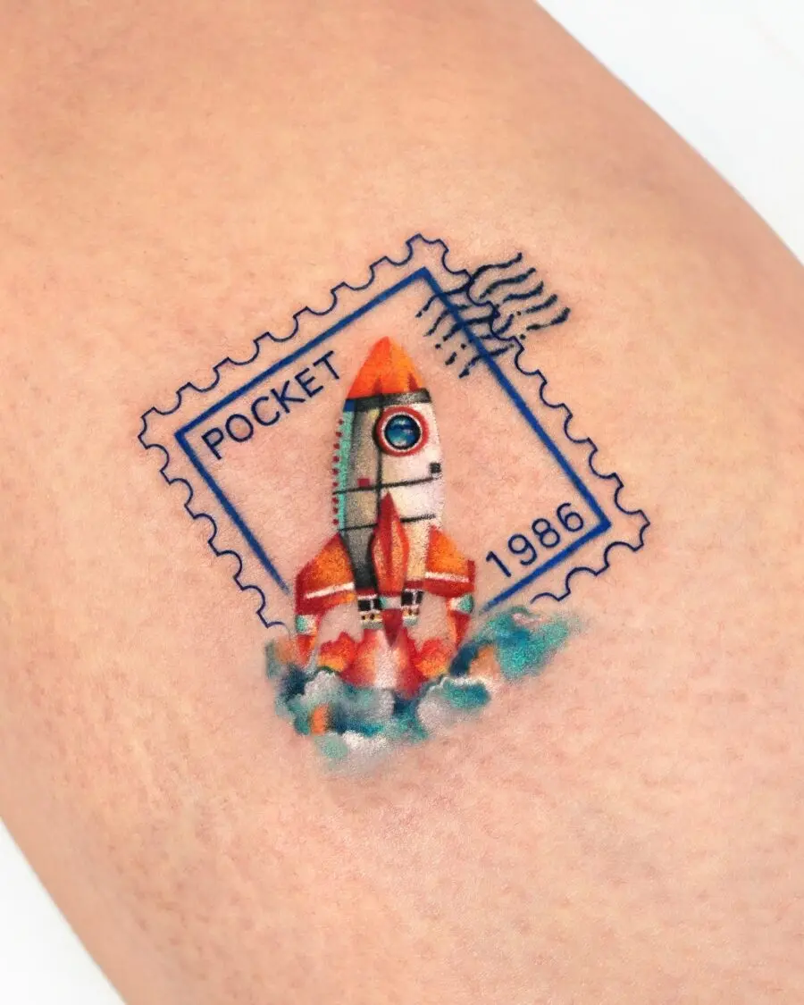Rocket-themed birthday tattoo with postal vibes