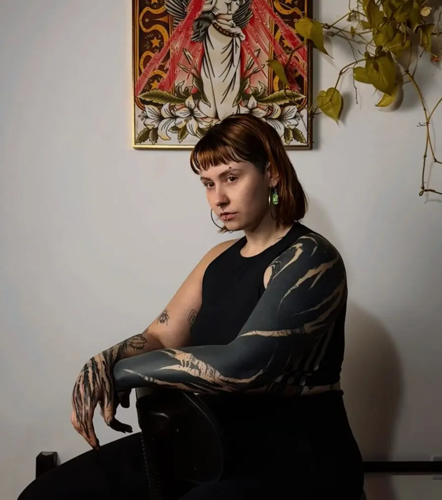 Striking black sleeve tattoo showcasing bold artistry