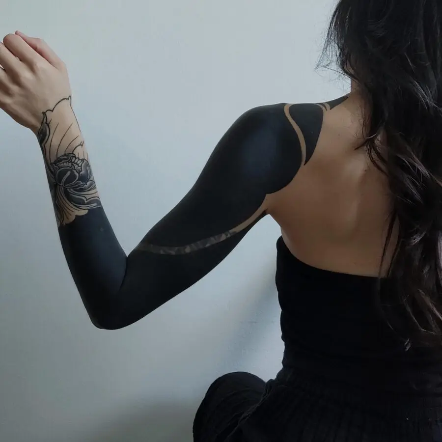 Artistic black sleeve tattoo with intricate details