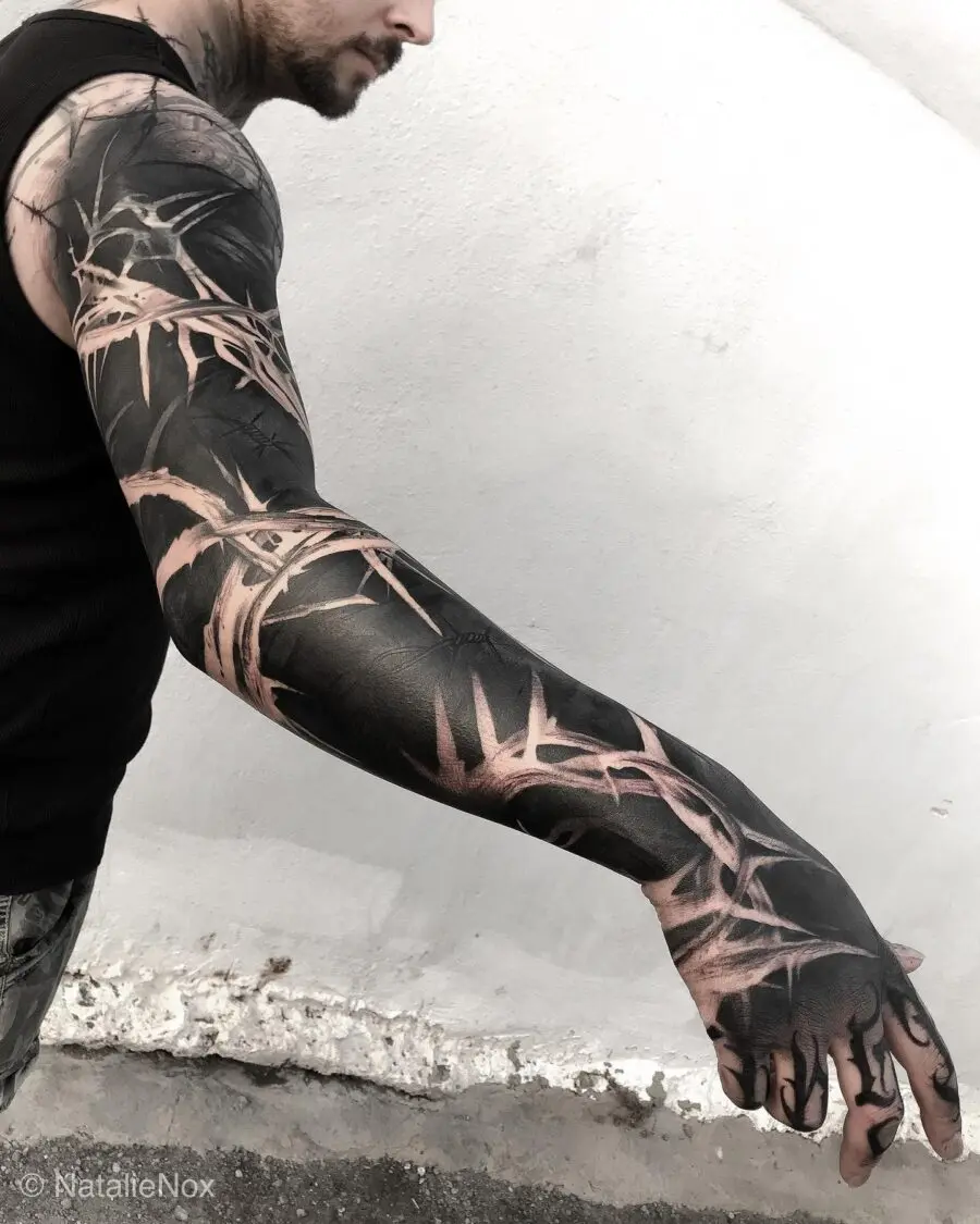 Bold black bamboo-inspired sleeve tattoo design